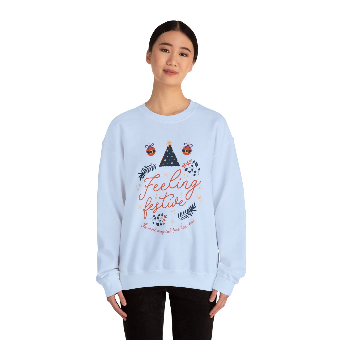 Woman wearing a light blue 'Feeling Festive' Christmas sweatshirt.