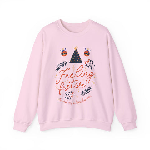 Pink sweatshirt with 'Feeling Festive' graphic featuring a Christmas tree and ornaments.