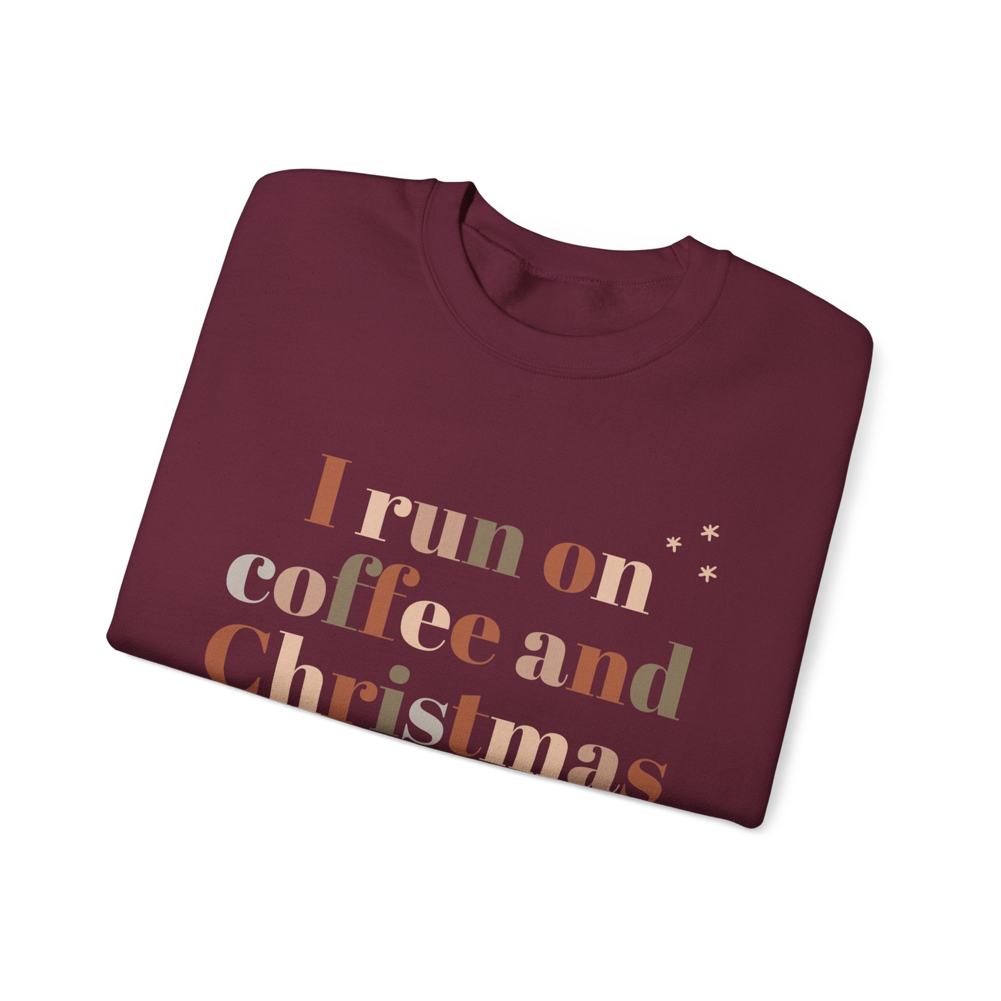Burgundy sweatshirt with 'I run on coffee and Christmas' text design.