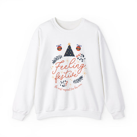 White sweatshirt with 'Feeling festive' graphic featuring a Christmas tree and ornaments.