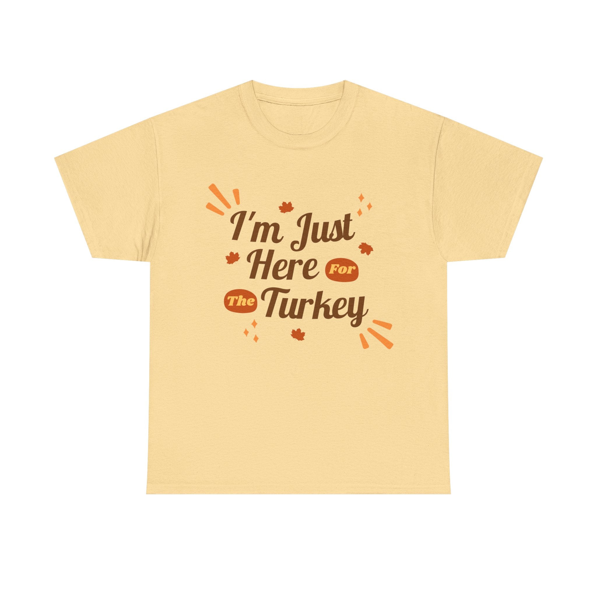 Beige t-shirt with the text 'I'm Just Here For The Turkey' and leaf graphics, perfect for Thanksgiving.
