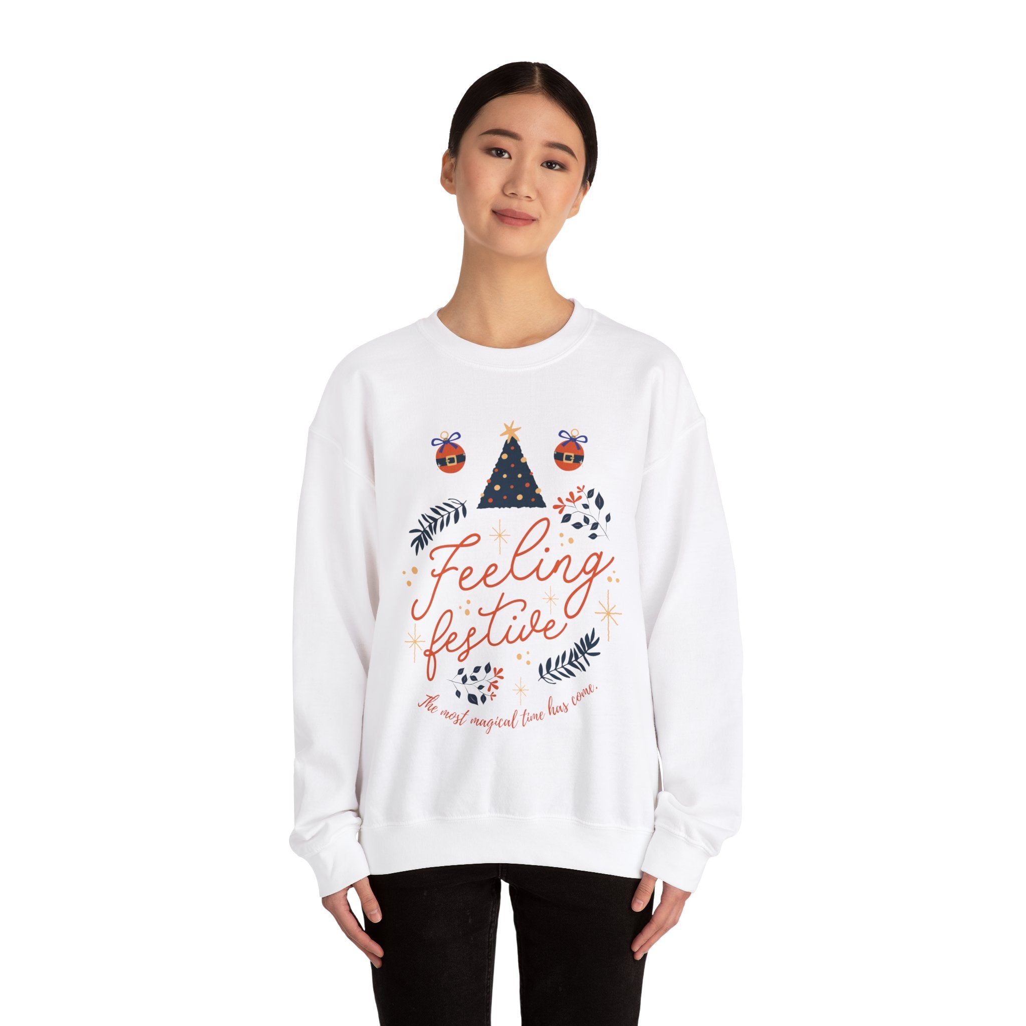 Woman in white 'Feeling Festive' Christmas sweatshirt with tree and ornament design.