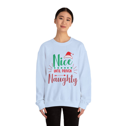 Woman wearing a light blue 'Nice Until Proven Naughty' Christmas sweatshirt.