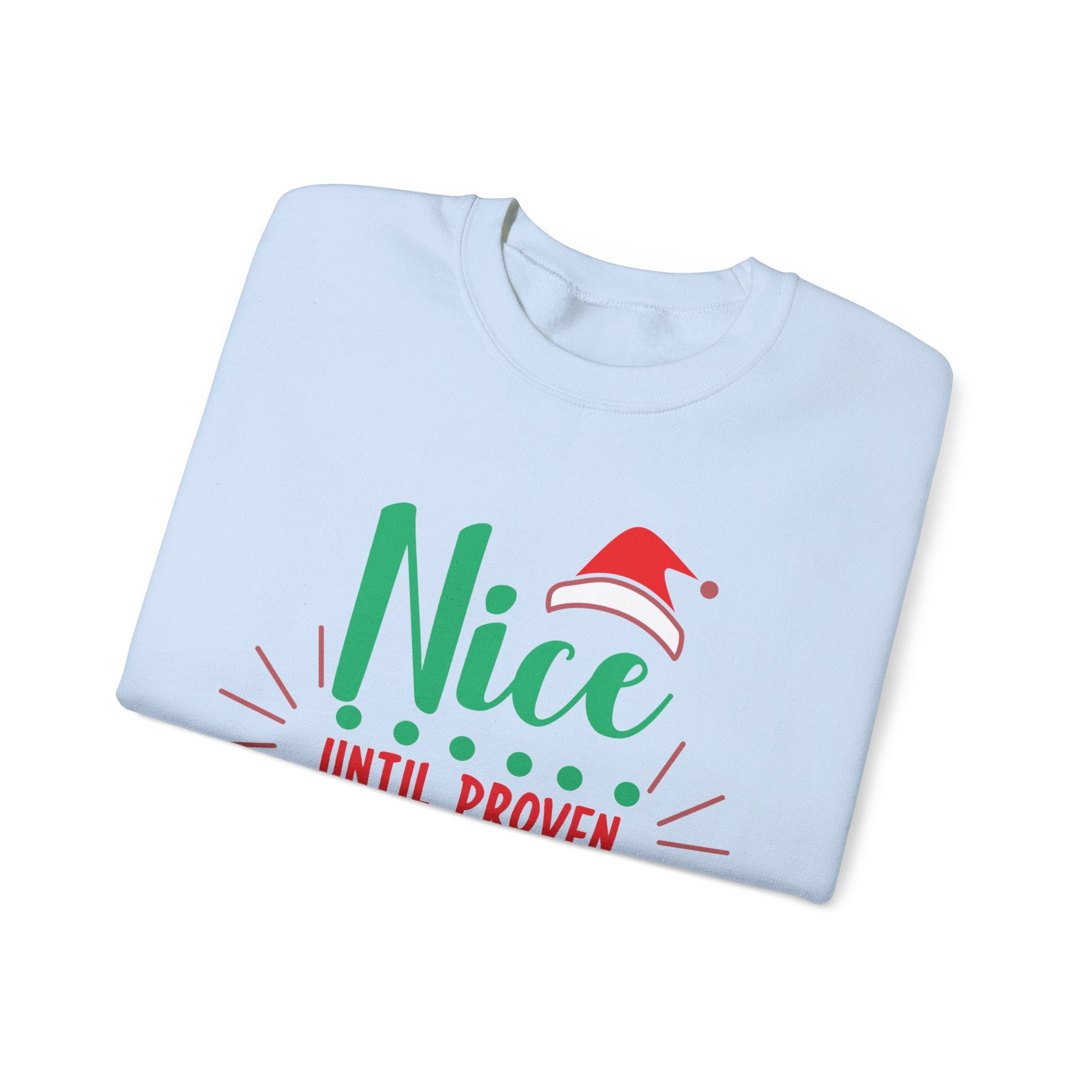 Folded light blue sweatshirt with the phrase "Nice Until Proven" and a Santa hat graphic.