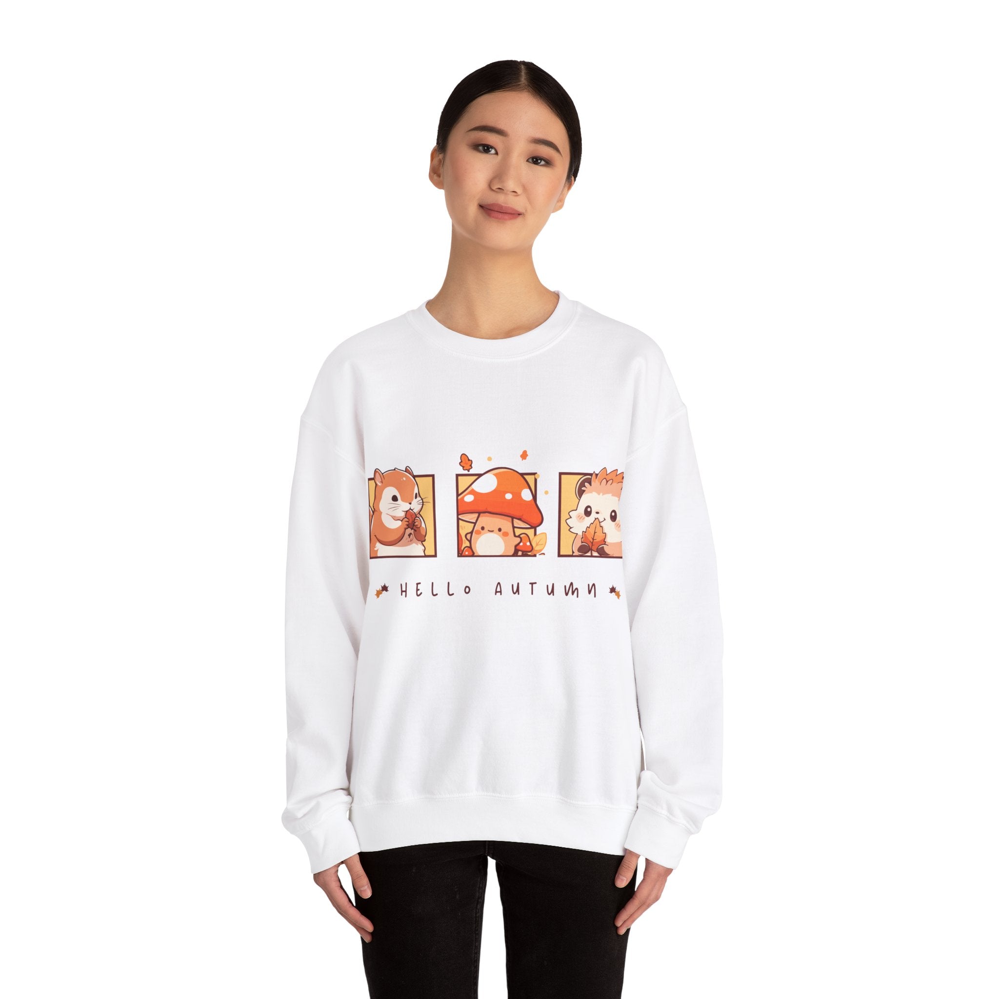 White sweatshirt featuring a 'Hello Autumn' design with squirrel, mushroom, and hedgehog cartoons.