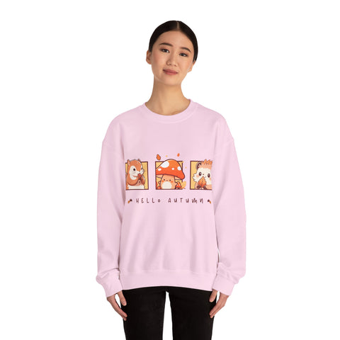 Woman wearing a pink "Hello Autumn" sweatshirt with cute cartoon squirrel, mushroom, and hedgehog graphics.