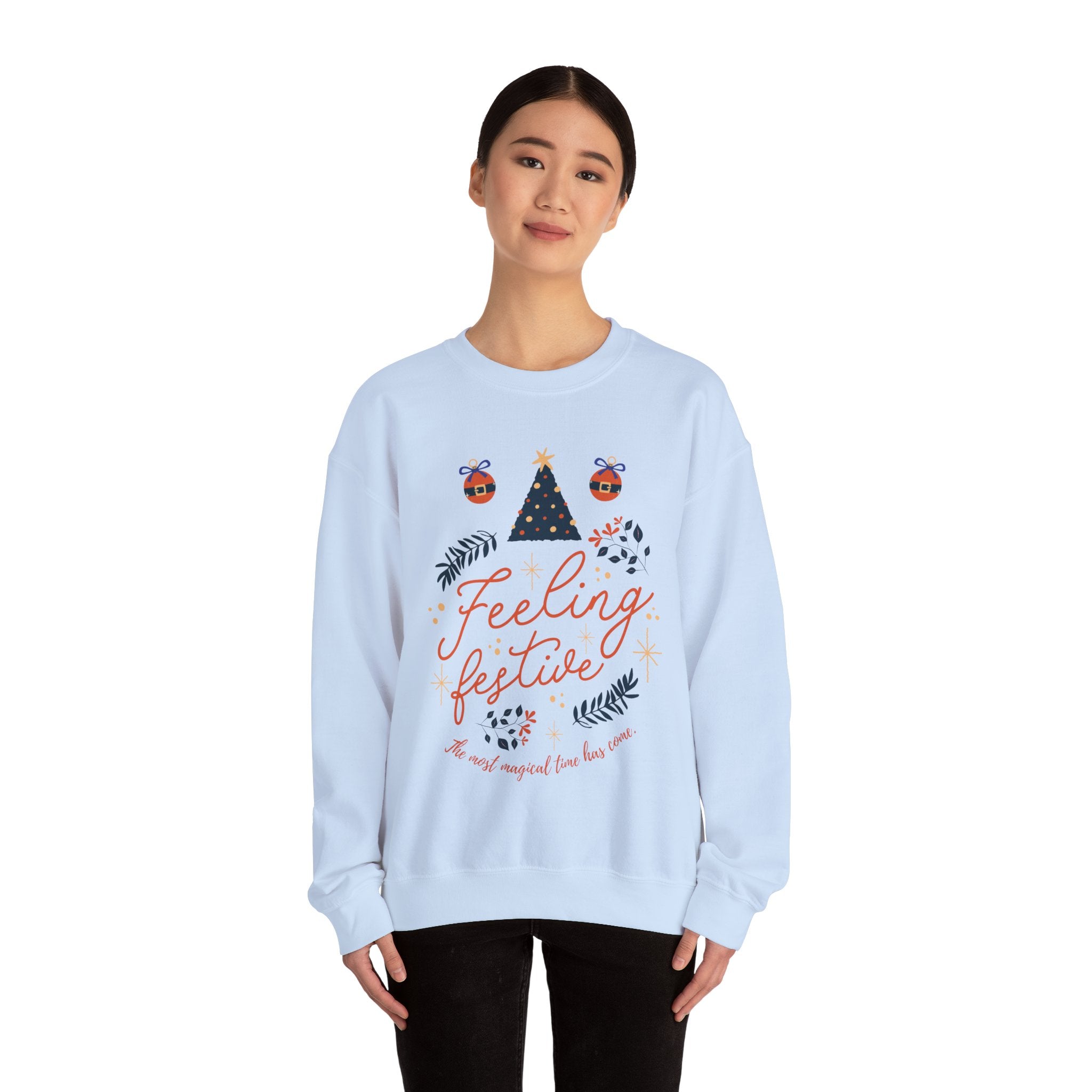 Light blue crewneck sweatshirt with 'Feeling Festive' graphic and Christmas ornament accents.
