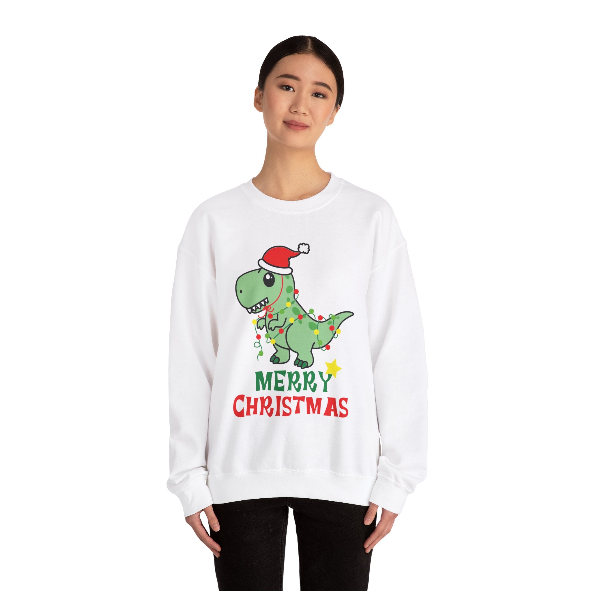 Woman wearing white Christmas sweatshirt with a dinosaur in a Santa hat and fairy lights graphic.