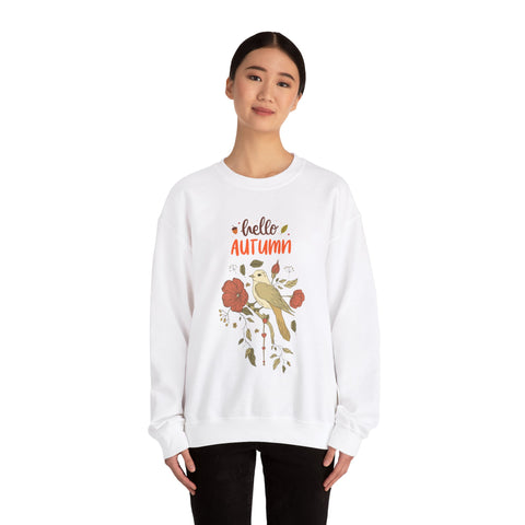 Woman wearing white sweatshirt with 'hello autumn' and bird floral graphic.