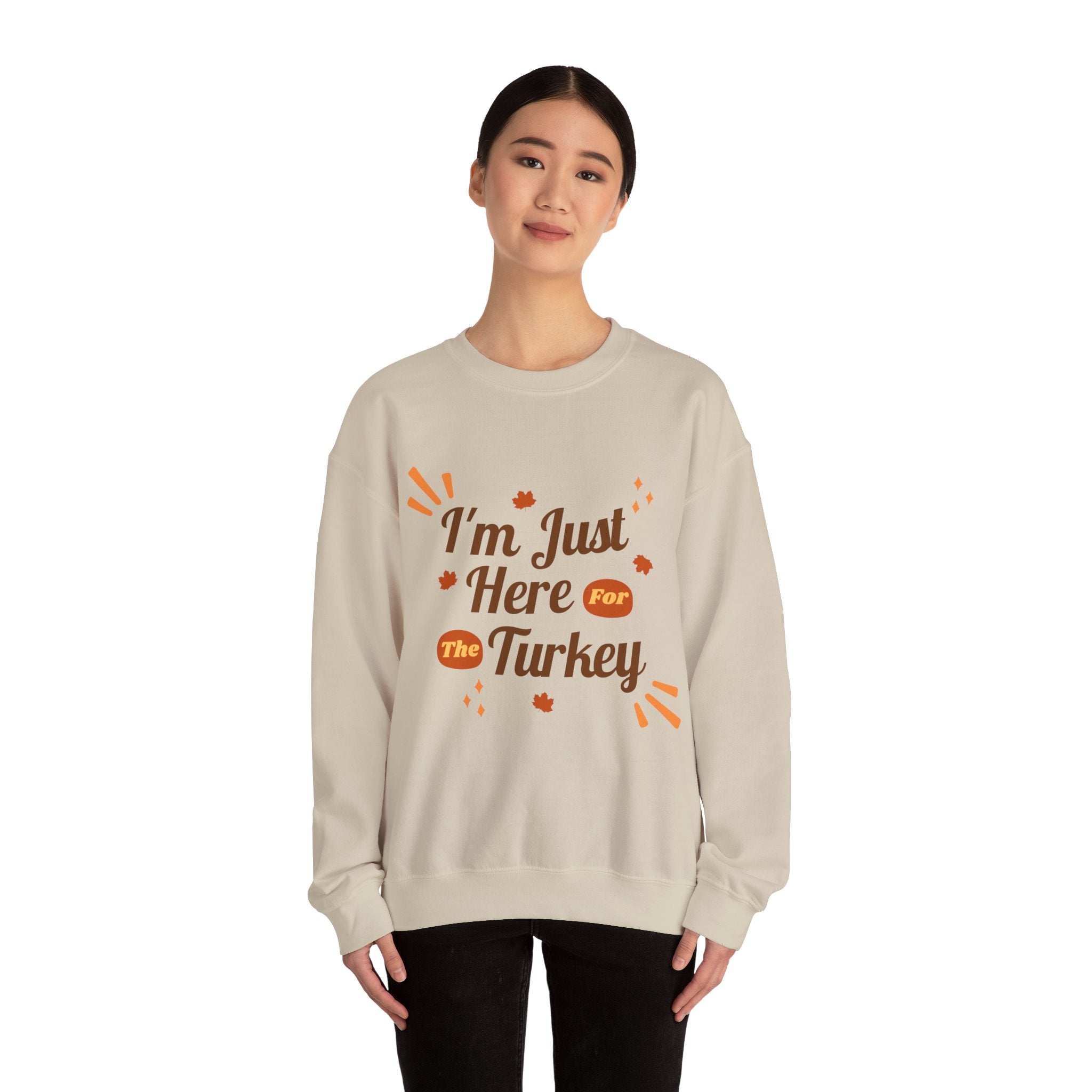 Woman wearing a beige 'I'm Just Here For The Turkey' Thanksgiving sweatshirt.