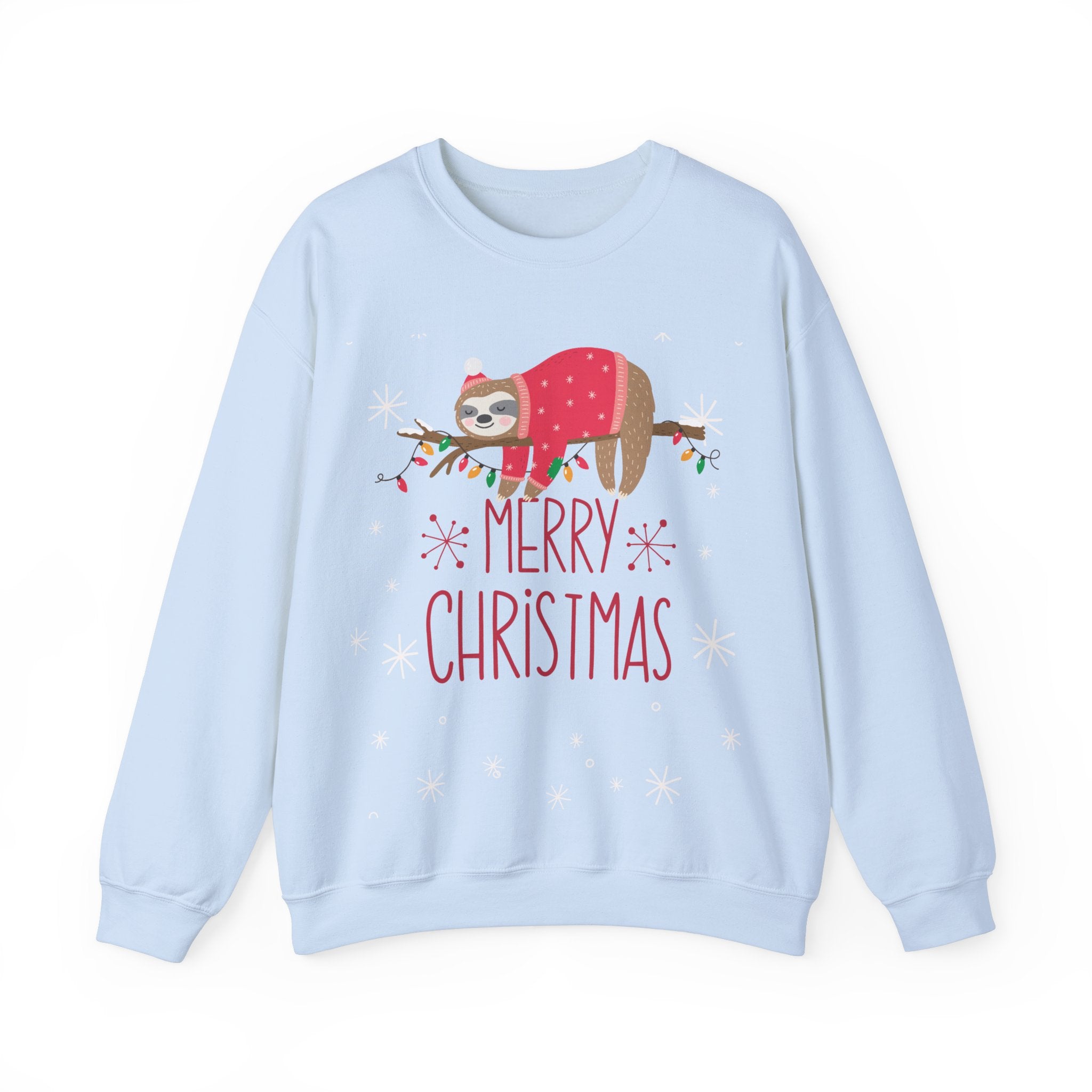 Light blue 'Merry Christmas' sweatshirt with sloth wearing a Santa hat and sweater, draped on a branch with lights.
