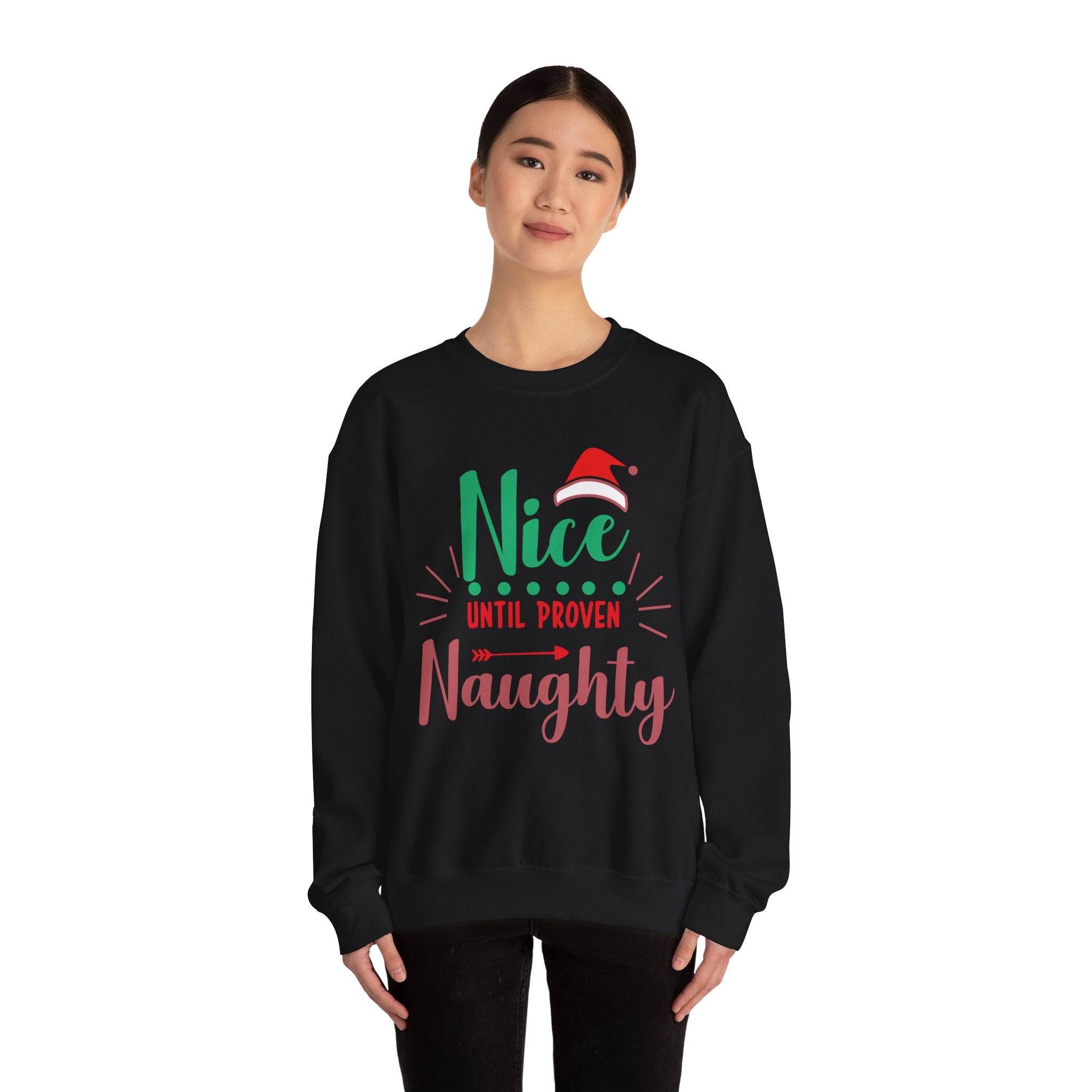 Woman wearing a black crewneck sweatshirt with 'Nice Until Proven Naughty' Christmas graphic.