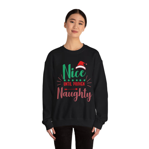 Woman wearing a black crewneck sweatshirt with 'Nice Until Proven Naughty' Christmas graphic.