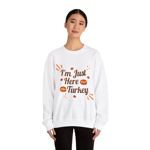 Woman wearing a white 'I'm Just Here For The Turkey' Thanksgiving sweatshirt.